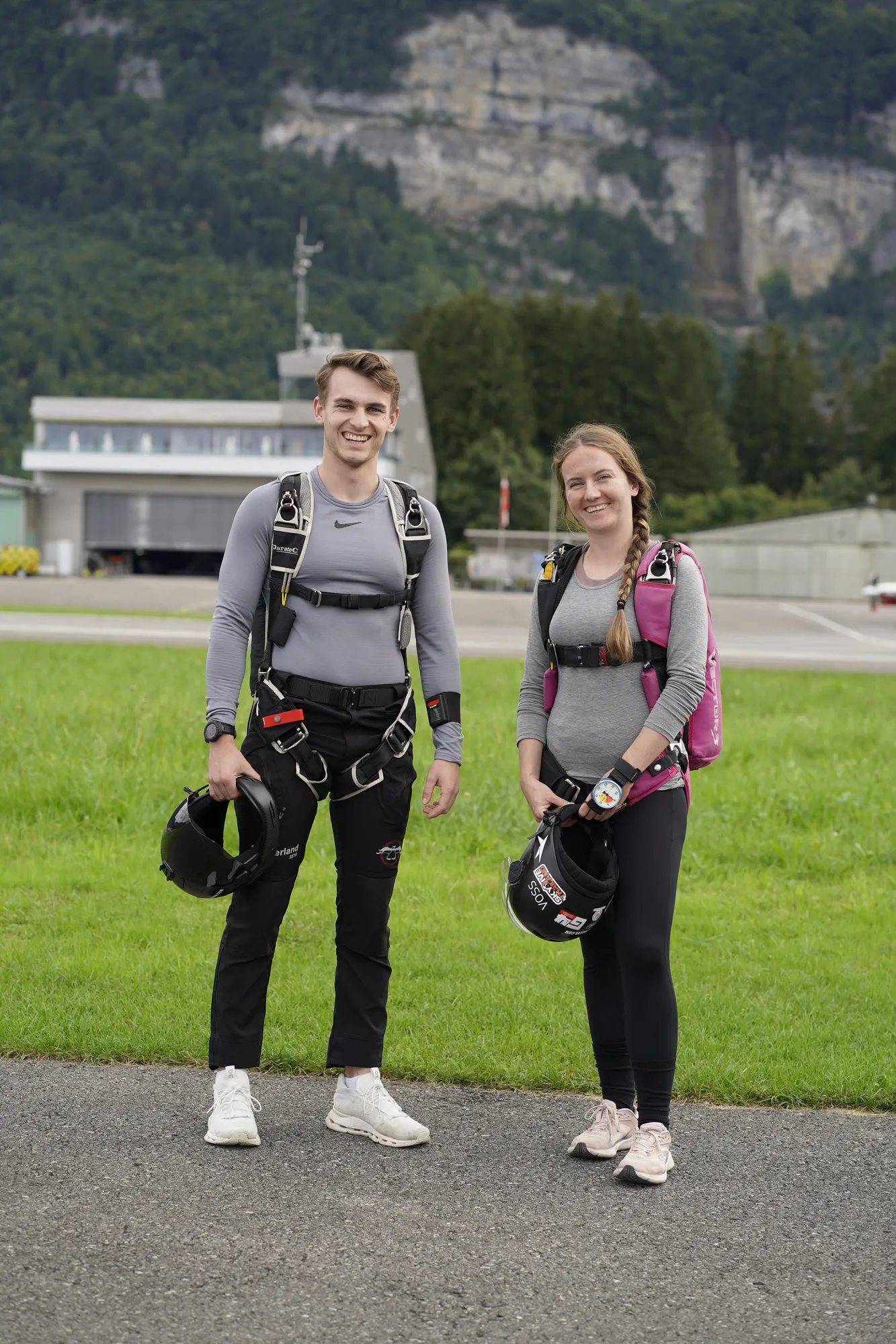 Two skydivers with their rigs at the dropzone